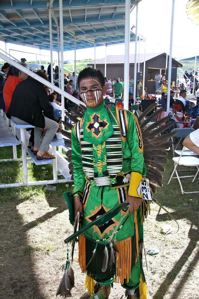 Powwow dancer in green regalia